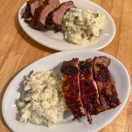 Picture of two plates of ribs and mashed potatoes