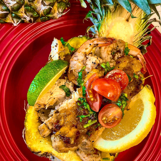 Close-up of Citrus Cuban Chicken & Shrimp Pineapple Bowl with sweet & spicy sauce